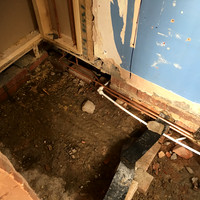 Existing cloakroom door removed and wall extended to create larger shower room