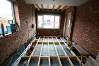 New joists with dpc to raise floor to match existing house floor
